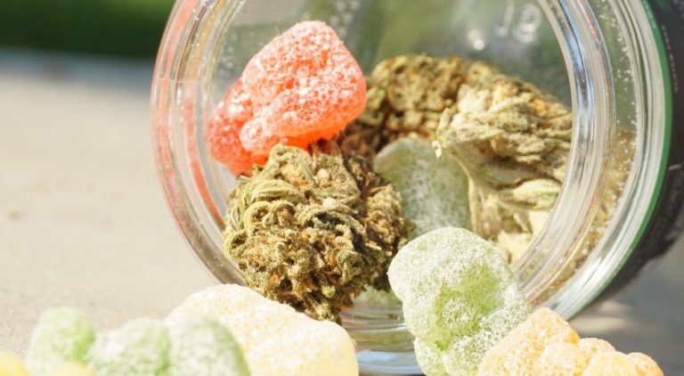 Jar spilling candies and cannabis