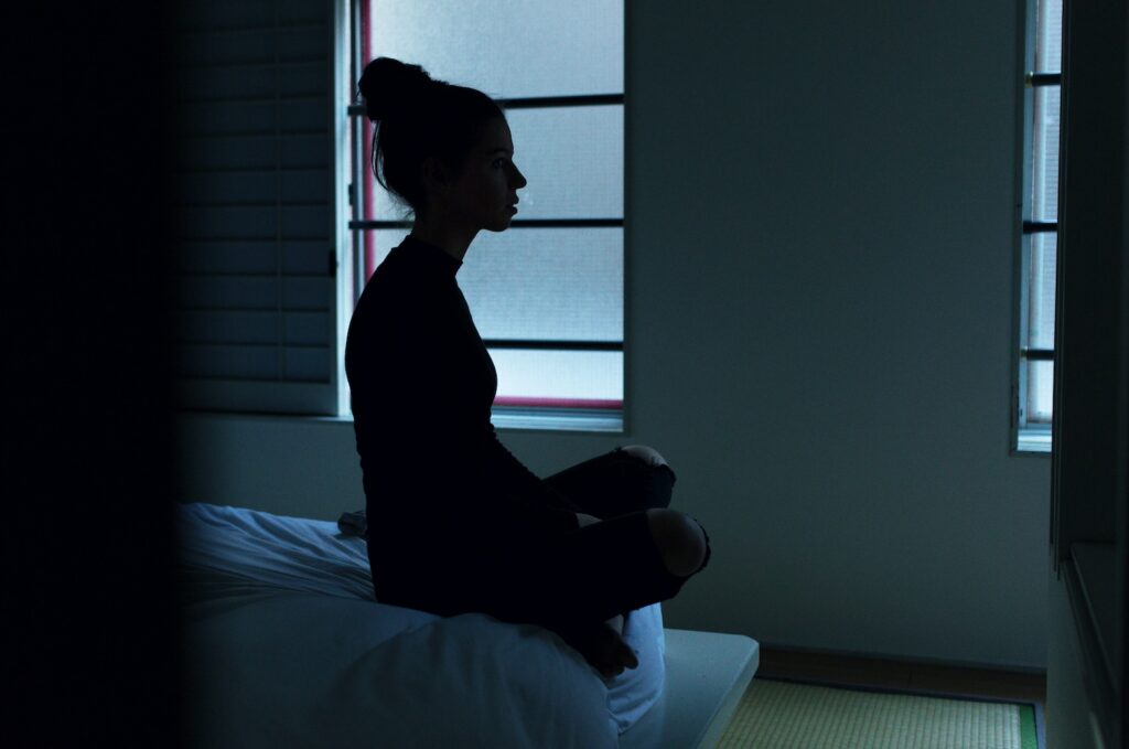 woman awake on bed